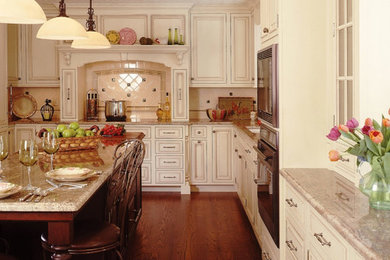 Large elegant l-shaped dark wood floor and brown floor eat-in kitchen photo in Other with an undermount sink, raised-panel cabinets, white cabinets, granite countertops, white backsplash, ceramic backsplash, stainless steel appliances and an island