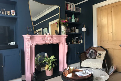 Design ideas for a large classic living room in Other with a reading nook, blue walls, a standard fireplace and a plastered fireplace surround.