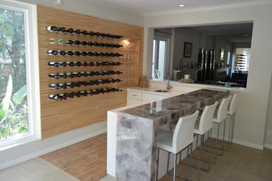 Inspiration for a large shabby-chic style l-shaped ceramic tile and beige floor seated home bar remodel in Los Angeles with an undermount sink and white cabinets