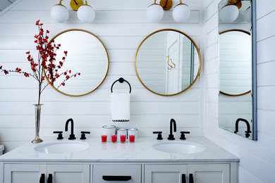 This is an example of a large modern family bathroom in Boston with shaker cabinets, white cabinets, an alcove bath, an alcove shower, a one-piece toilet, white tiles, white walls, marble flooring, a submerged sink, marble worktops, black floors, a shower curtain, white worktops, double sinks, a built in vanity unit and tongue and groove walls.