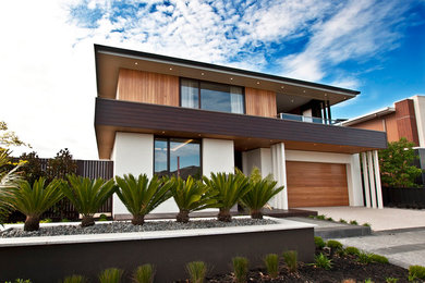 Inspiration for a large modern two-storey white exterior in Melbourne with mixed siding.