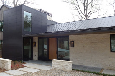 Huge transitional white three-story stone exterior home idea in Atlanta with a metal roof and a brown roof