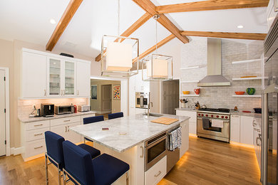 Inspiration for an eclectic u-shaped light wood floor and beige floor eat-in kitchen remodel in Other with an undermount sink, recessed-panel cabinets, white cabinets, marble countertops, gray backsplash, subway tile backsplash, an island and gray countertops