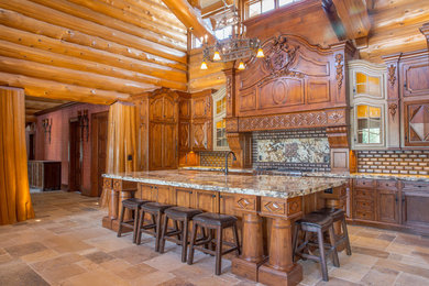 Photo of an expansive l-shaped eat-in kitchen in Other with recessed-panel cabinets, distressed cabinets, granite benchtops, stainless steel appliances, travertine floors and with island.