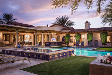 Mid-sized tuscan backyard concrete and custom-shaped hot tub photo in San Francisco