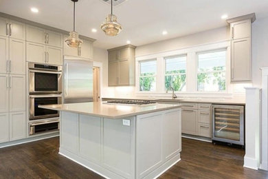 Mid-sized traditional kitchen in Austin with with island, shaker cabinets, an undermount sink, grey cabinets, stainless steel appliances and dark hardwood floors.