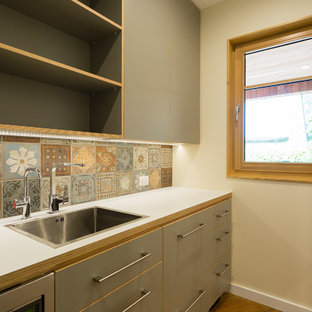 Modern kitchen pantry remodeling - Inspiration for a modern light wood floor kitchen pantry remodel in Christchurch with a drop-in sink, recessed-panel cabinets, gray cabinets, laminate countertops, multicolored backsplash and ceramic backsplash
