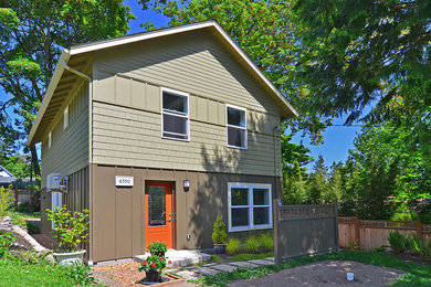 Example of a mid-sized arts and crafts two-story wood exterior home design in Seattle
