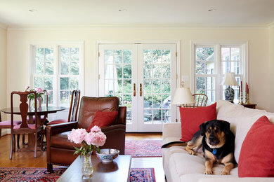 Living room - mid-sized traditional open concept medium tone wood floor living room idea in DC Metro with beige walls and a standard fireplace