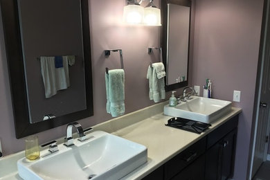 Bathroom - bathroom idea in St Louis with dark wood cabinets and a vessel sink
