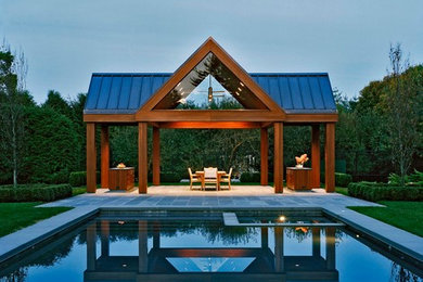 This is an example of a contemporary rectangular pool in New York with a pool house.
