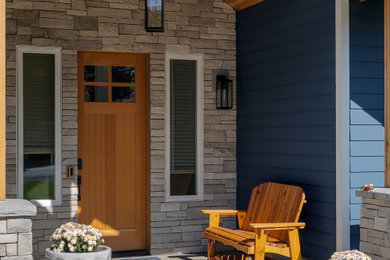 Inspiration for a mid-sized transitional concrete floor and vaulted ceiling entryway remodel in Seattle with a medium wood front door