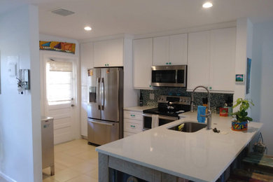 Inspiration for a small craftsman l-shaped ceramic tile and yellow floor eat-in kitchen remodel in Other with an undermount sink, shaker cabinets, white cabinets, quartz countertops, multicolored backsplash, mosaic tile backsplash, stainless steel appliances, no island and white countertops