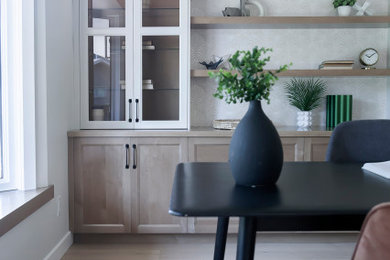 Mid-sized minimalist freestanding desk light wood floor study room photo in Other with white walls