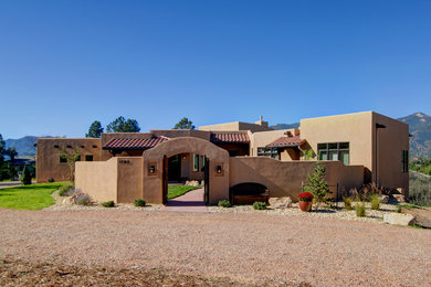 Design ideas for a large one-storey stucco beige exterior in Denver with a flat roof.