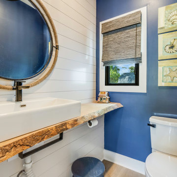 Chic Coastal Powder Room with Deep Blue Accent Wall and Natural Elements