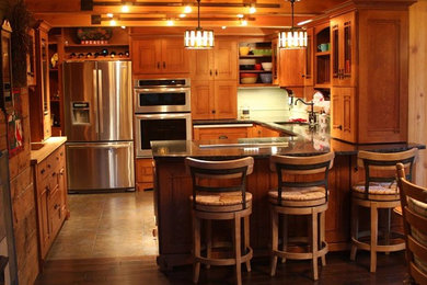 Open concept kitchen - mid-sized craftsman u-shaped ceramic tile open concept kitchen idea in Seattle with an undermount sink, shaker cabinets, medium tone wood cabinets, granite countertops, green backsplash, ceramic backsplash, stainless steel appliances and an island