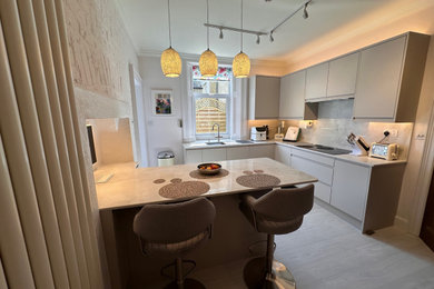 Inspiration for a medium sized contemporary dining room in Other with banquette seating, white walls, light hardwood flooring, no fireplace, beige floors and brick walls.