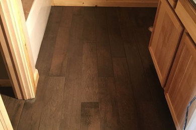 Inspiration for a mid-sized rustic master brown tile and porcelain tile porcelain tile bathroom remodel in Other