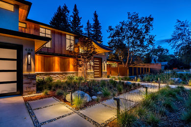 This is an example of a large modern two-storey red exterior in San Diego with wood siding and a hip roof.
