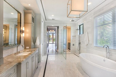 Large transitional master bathroom in Miami with shaker cabinets, grey cabinets, a freestanding tub, an open shower, gray tile, marble, grey walls, marble floors, an undermount sink, granite benchtops, grey floor, an open shower and brown benchtops.