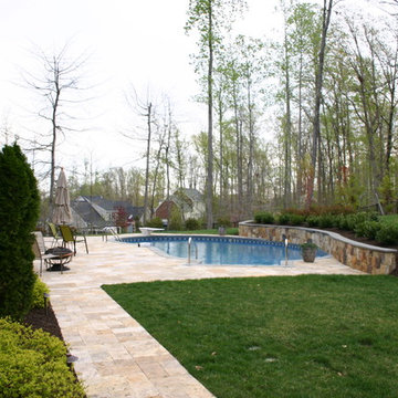 Natural Pool with Travertine Deck & Stone Retaining Wall