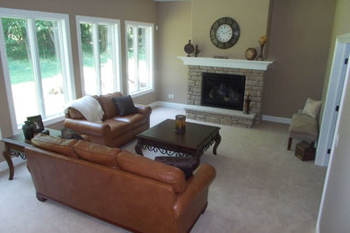 Example of a classic enclosed carpeted family room design in Cleveland with a standard fireplace and a stone fireplace