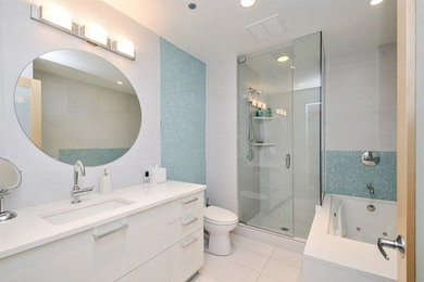 Bathroom - large modern 3/4 beige tile, blue tile and mosaic tile ceramic tile and white floor bathroom idea in Chicago with white cabinets, a one-piece toilet, white walls, an undermount sink, flat-panel cabinets, granite countertops and a hinged shower door