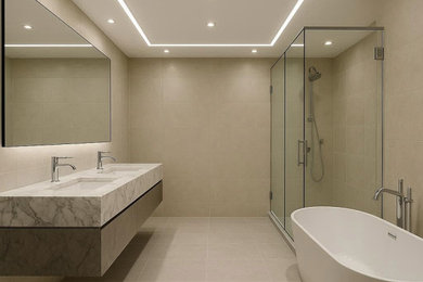 Freestanding bathtub - large freestanding bathtub idea in Toronto with a floating vanity