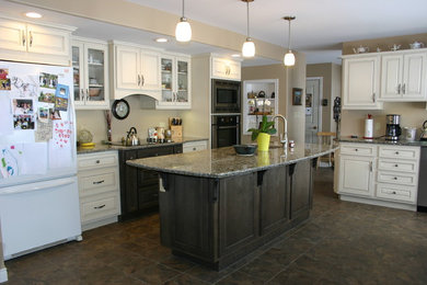 Mid-sized elegant l-shaped linoleum floor eat-in kitchen photo in Other with an undermount sink, raised-panel cabinets, white cabinets, quartz countertops, stainless steel appliances and an island