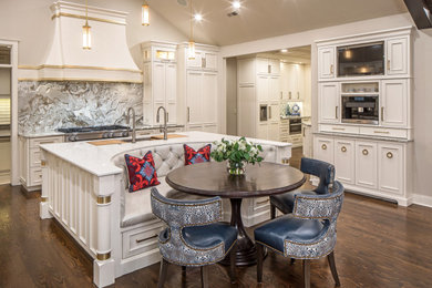 Example of a large classic u-shaped dark wood floor, brown floor and vaulted ceiling eat-in kitchen design in Omaha with an undermount sink, recessed-panel cabinets, white cabinets, quartzite countertops, gray backsplash, marble backsplash, paneled appliances, an island and white countertops