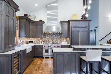 Mid-sized transitional l-shaped light wood floor eat-in kitchen photo in Salt Lake City with a farmhouse sink, recessed-panel cabinets, gray cabinets, quartz countertops, stainless steel appliances and an island