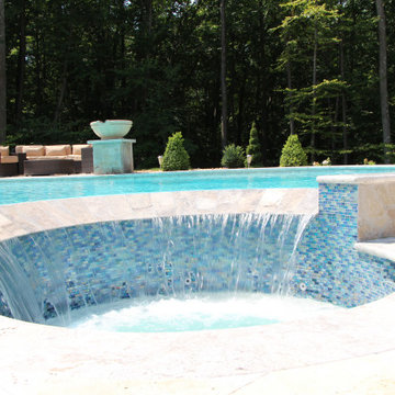 Contemporary Freeform Gunite Pool with Raised Spa and Water Features