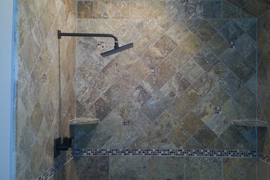 Example of a mid-sized classic master brown tile and porcelain tile porcelain tile alcove shower design in New York with an undermount sink, furniture-like cabinets, dark wood cabinets, quartzite countertops, a two-piece toilet and beige walls