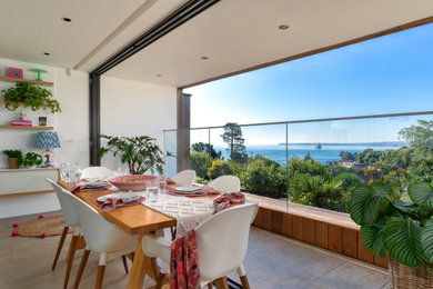 This is an example of a contemporary dining room in Devon.