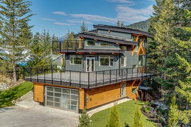 Large trendy gray three-story concrete fiberboard flat roof photo in Vancouver