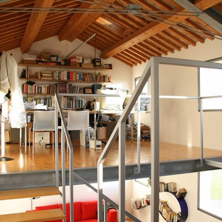 Medium sized modern home office and library in Venice with white walls, light hardwood flooring, a reading nook, a freestanding desk and yellow floors.