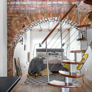 This is an example of a small scandi basement in Gothenburg with white walls, medium hardwood flooring and no fireplace.