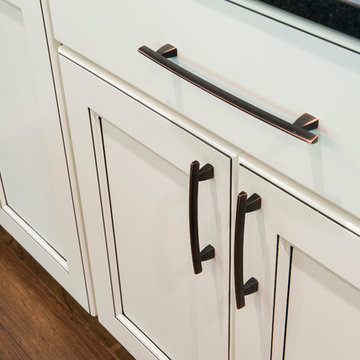 White cabinets with dark glaze and oil rubbed bronze pulls