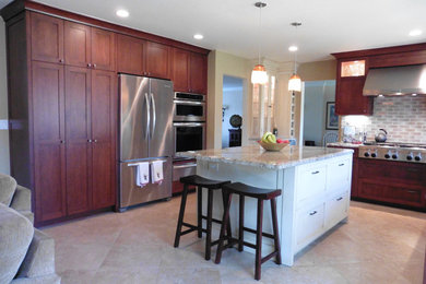 Inspiration for a mid-sized timeless u-shaped porcelain tile and beige floor eat-in kitchen remodel in Los Angeles with shaker cabinets, granite countertops, stainless steel appliances, an island, an undermount sink, medium tone wood cabinets, gray backsplash and ceramic backsplash