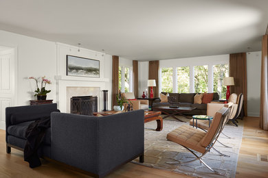 Photo of a mid-sized contemporary formal open concept living room in Minneapolis with white walls, light hardwood floors, a standard fireplace, a tile fireplace surround, no tv and beige floor.