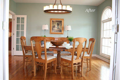 Large elegant medium tone wood floor enclosed dining room photo in Louisville with blue walls