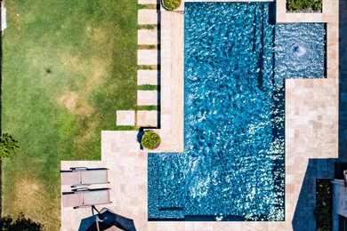 Inspiration for a mid-sized transitional backyard stone and rectangular pool fountain remodel in Austin