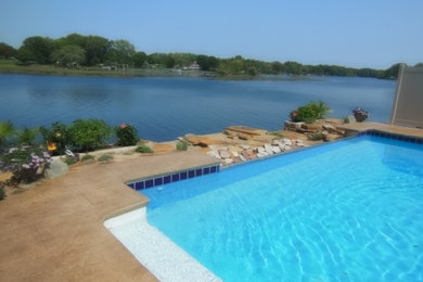Inspiration for a large timeless backyard stone pool fountain remodel in Other