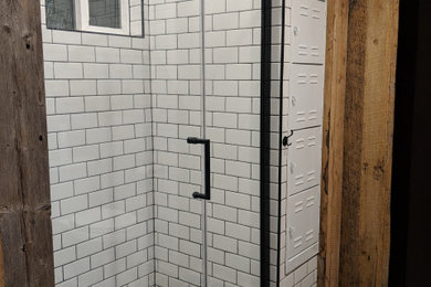 Eclectic black and white tile and subway tile alcove shower photo in Other with white walls