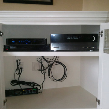 Built In Shelving and Cabinets To Hide Electronics and Surround Fireplace
