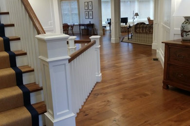 Design ideas for a mid-sized transitional wood straight staircase in Boston with painted wood risers and wood railing.