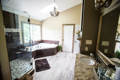 Huge mountain style master brown tile and mosaic tile porcelain tile walk-in shower photo in New York with an undermount sink, recessed-panel cabinets, gray cabinets, granite countertops, a hot tub, a one-piece toilet and beige walls