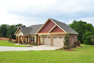 Example of a large arts and crafts beige one-story mixed siding gable roof design in Other