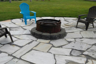 Stone patio photo in Seattle with a fire pit